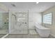 Modern bathroom featuring a glass enclosed shower and freestanding tub at 4363 S Atlantic Ave, Ponce Inlet, FL 32127