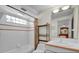 Well-lit bathroom with a shower/tub combo, tiled walls, and vanity at 4363 S Atlantic Ave, Ponce Inlet, FL 32127