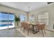 Bright dining room with a table that seats six, a sliding glass door, and an ocean view at 4363 S Atlantic Ave, Ponce Inlet, FL 32127