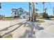 Stunning exterior of home with a circular driveway and well-maintained landscaping and lush vegetation at 4363 S Atlantic Ave, Ponce Inlet, FL 32127