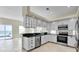 Modern kitchen equipped with stainless steel appliances, white cabinetry, and dark countertops with ocean views at 4363 S Atlantic Ave, Ponce Inlet, FL 32127