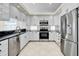 Modern kitchen features stainless steel appliances, white cabinetry, and granite countertops at 4363 S Atlantic Ave, Ponce Inlet, FL 32127