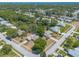 An aerial view of a home on a corner lot in a mature neighborhood with a pond at 4589 Alder Dr, Port Orange, FL 32127