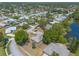 A neighborhood aerial shot with mature trees, a pond, and lush landscaping in a community setting at 4589 Alder Dr, Port Orange, FL 32127