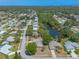 An aerial shot of homes and tree-lined streets, with a pond view and the city skyline in the distance at 4589 Alder Dr, Port Orange, FL 32127