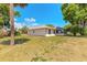 Lush backyard featuring a well-maintained lawn, mature trees, and a charming screened-in porch at 4589 Alder Dr, Port Orange, FL 32127