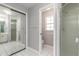 Bathroom featuring a walk-in shower, toilet room, and mirrored closet at 4589 Alder Dr, Port Orange, FL 32127