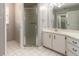Bathroom featuring a glass-enclosed shower, white cabinets, and white tile floors at 4589 Alder Dr, Port Orange, FL 32127