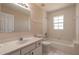 Bright bathroom featuring a tub-shower combination, white tile, and a clean, modern vanity at 4589 Alder Dr, Port Orange, FL 32127