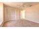 Well-lit bedroom featuring a ceiling fan, carpet, and a closet at 4589 Alder Dr, Port Orange, FL 32127