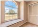 Bright bedroom features a large arched window, closet, and a comfortable seating area at 4589 Alder Dr, Port Orange, FL 32127