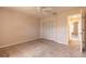Bedroom with neutral carpet, closet, and ceiling fan, creating a serene and comfortable space at 4589 Alder Dr, Port Orange, FL 32127