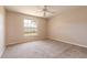 Cozy bedroom with neutral carpet, a ceiling fan, and a bright window at 4589 Alder Dr, Port Orange, FL 32127