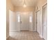 Welcoming entryway with a charming light fixture and neutral tile flooring at 4589 Alder Dr, Port Orange, FL 32127