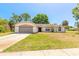 Charming single-story home with a well-maintained lawn, attached garage, and inviting entryway at 4589 Alder Dr, Port Orange, FL 32127