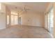 Bright living room with views to the kitchen and sunroom through sliding glass doors at 4589 Alder Dr, Port Orange, FL 32127