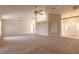 Open-concept living room with vaulted ceilings and a view of the entry and kitchen at 4589 Alder Dr, Port Orange, FL 32127