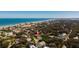 Gorgeous aerial view of the community with a glimpse of the ocean and blue skies at 4745 Dixie Dr, Ponce Inlet, FL 32127