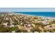 Aerial view of a house with proximity to the beach and surrounding neighborhood at 4745 Dixie Dr, Ponce Inlet, FL 32127