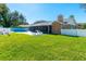 Expansive backyard with a manicured lawn, white fence, and outdoor seating near the pool at 4745 Dixie Dr, Ponce Inlet, FL 32127