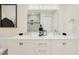 Bright bathroom showcases double sinks, decorative mirror, and modern fixtures at 4745 Dixie Dr, Ponce Inlet, FL 32127