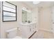 Bright bathroom with double vanity, modern fixtures, and ample lighting at 4745 Dixie Dr, Ponce Inlet, FL 32127