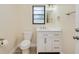 Bright bathroom features white vanity, updated fixtures, toilet, and natural light at 4745 Dixie Dr, Ponce Inlet, FL 32127