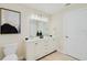 Bright bathroom features double sinks, vanity, and modern toilet at 4745 Dixie Dr, Ponce Inlet, FL 32127