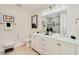 Well-lit bathroom features double sinks, a decorative mirror, and tiled shower at 4745 Dixie Dr, Ponce Inlet, FL 32127