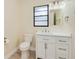 Bright bathroom featuring a white vanity, updated fixtures, and modern toilet at 4745 Dixie Dr, Ponce Inlet, FL 32127
