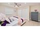 Inviting bedroom with wood floors, a ceiling fan, and closet storage at 4745 Dixie Dr, Ponce Inlet, FL 32127