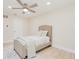 Neutral bedroom features a ceiling fan and a single bed with comfortable linens at 4745 Dixie Dr, Ponce Inlet, FL 32127