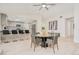 Open dining area featuring a glass table and views into kitchen with bar top seating at 4745 Dixie Dr, Ponce Inlet, FL 32127
