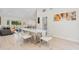 Bright dining room with modern furnishings and views of the living area and outdoor access, promoting seamless living at 4745 Dixie Dr, Ponce Inlet, FL 32127