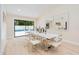 Elegant dining area with modern table, seating, and sliding glass doors that provide access to an outdoor area at 4745 Dixie Dr, Ponce Inlet, FL 32127