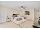 Spacious main bedroom boasts a king bed, neutral decor, and wood-look tile flooring at 4745 Dixie Dr, Ponce Inlet, FL 32127