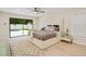 Bright main bedroom with pool view, king bed, and stylish decor at 4745 Dixie Dr, Ponce Inlet, FL 32127