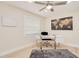 Bright home office offers a modern desk, ceiling fan, and neutral decor at 4745 Dixie Dr, Ponce Inlet, FL 32127