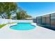 Beautiful backyard pool with a white fence, mature trees, and an enclosed sunroom at 4745 Dixie Dr, Ponce Inlet, FL 32127