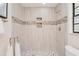 Modern shower with decorative tile accents and a built-in niche at 4745 Dixie Dr, Ponce Inlet, FL 32127