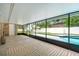 Spacious sunroom with tile floors, large windows, and views of the pool and outdoor area at 4745 Dixie Dr, Ponce Inlet, FL 32127