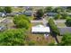 Aerial view of the home with a new silver metal roof, spacious backyard, mature trees, and fire pit at 4836 Ne 26Th Ter, Ocala, FL 34479