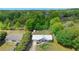Aerial view of the home with a new silver metal roof, spacious backyard, mature trees, and lush landscaping at 4836 Ne 26Th Ter, Ocala, FL 34479