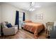 Neutral bedroom with a glider chair, crib, and window, perfect for a Bedroom at 4836 Ne 26Th Ter, Ocala, FL 34479