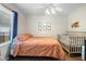 Comfortable bedroom with natural light, a crib, and wall art for  at 4836 Ne 26Th Ter, Ocala, FL 34479