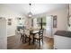 Dining area with wood floors, a modern chandelier, and lots of natural light at 4836 Ne 26Th Ter, Ocala, FL 34479