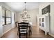Dining area featuring wood floors, a modern chandelier, and custom decorative wall art at 4836 Ne 26Th Ter, Ocala, FL 34479