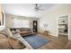 Comfortable living room with a large sectional, modern ceiling fan, and lots of natural light at 4836 Ne 26Th Ter, Ocala, FL 34479