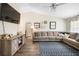 Bright living room with a large sectional, modern ceiling fan, and decorative wall art at 4836 Ne 26Th Ter, Ocala, FL 34479