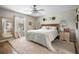 Cozy main bedroom with plush carpeting, a ceiling fan, and serene decor at 4836 Ne 26Th Ter, Ocala, FL 34479